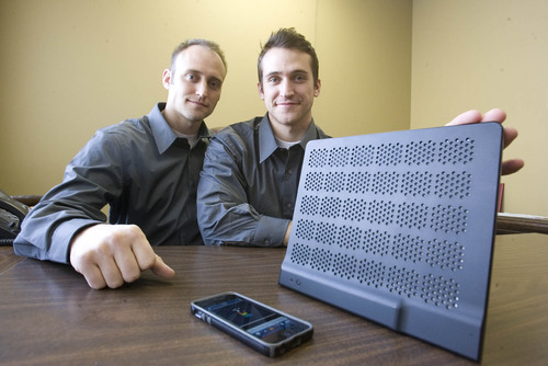 Paul Fraughton  |  The Salt Lake Tribune
Adam Marriott and his brother Wesley show off their company's thin wireless speaker designed to work with mobile devices. Their startup company, CoverPlay, will take the speaker to the Consumer Electronics Show in Las Vegas.  Friday, January 4, 2013