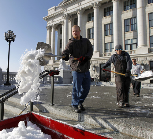 Al Hartmann  |  The Salt Lake Tribune
Workers at  the Utah State Capitol scrape snow  in prepartation for Gary Herbert's gubernatorial inauguration to be held Monday.