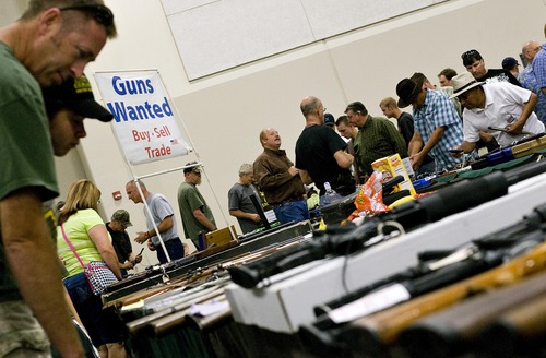 Djamila Grossman  |  The Salt Lake Tribune

People look at guns and rifles at the Rocky Mountain Gun Show in the South Towne Expo Center in Sandy, Utah, on Saturday, Aug. 13, 2011.