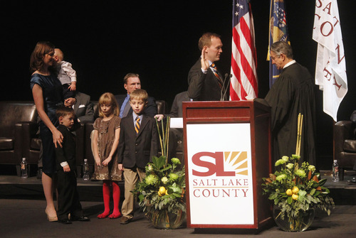 Al Hartmann  |  The Salt Lake Tribune
Salt Lake County Mayor-elect Ben McAdams, with his family behind him, is sworn into office Monday by Judge Andrew Valdez, of the  Utah 3rd District Juvenile Court. The ceremony took place at the Rose Wagner Theatre, a county owned facility.