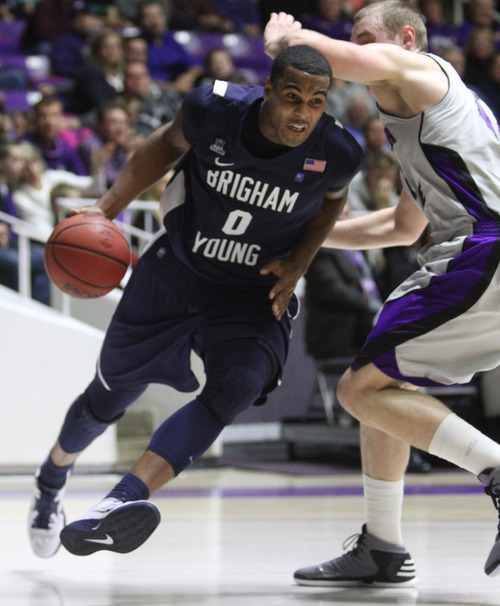 Rick Egan  | The Salt Lake Tribune 

Brigham Young Cougars forward Brandon Davies (0) takes the ball to the hoop,  pastWeber State Wildcats center Kyle Tresnak (44) in basketball action, BYU vs. Weber State, in Ogden, Saturday, December 15, 2012.