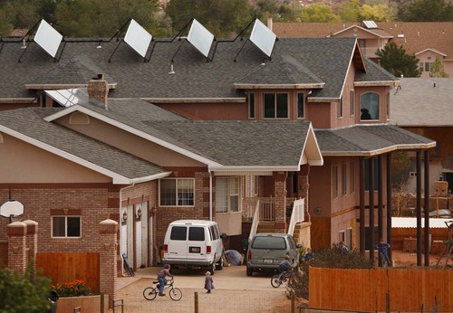 Children ride bikes behind the walls of their home in the twin cities of Hildale, Utah, and Colorado City, Ariz. Most of the property there is part of the state-controlled UEP trust, and is home to many members of Warren Jeffs' FLDS church. 
Trent Nelson/The Salt Lake Tribune