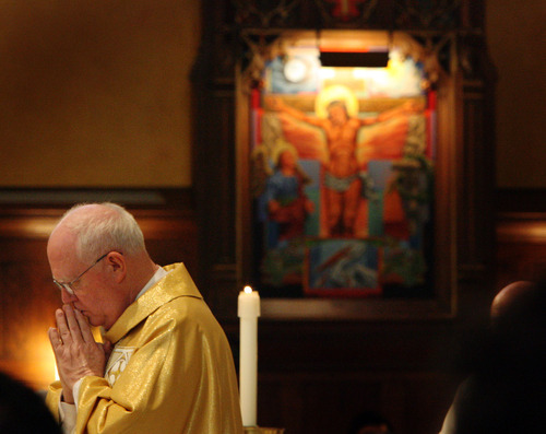 Tribune file photo
Utah's former Catholic Bishop George Niederauer prays during his farewell mass at the Cathedral of the Madeleine on Feb. 5, 2006.