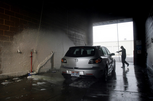 Rick Egan  | The Salt Lake Tribune 

Marvin Gonzalez washes a car at a car wash on North Temple, Monday, January 7, 2013. Rep. Eric Hutchings claims a car wash scammed him, and may be scamming others -- something he hopes to stop with legislation