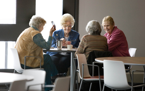 Paul Fraughton  |   Salt Lake Tribune
Pat Scoman, left, Velda Harman, Maryln Fisher, right, and Carolyn Robinette, back to camera, enjoy an afternoon card game at the new senior center in Draper.