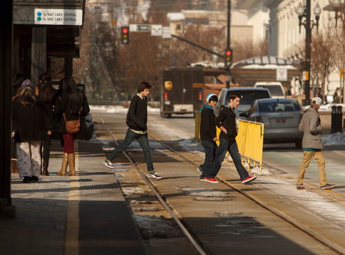 Trent Nelson  |  The Salt Lake Tribune
Pedestrians crossing the TRAX lines outside of the crosswalk are a common sight all around transit stations and lines.