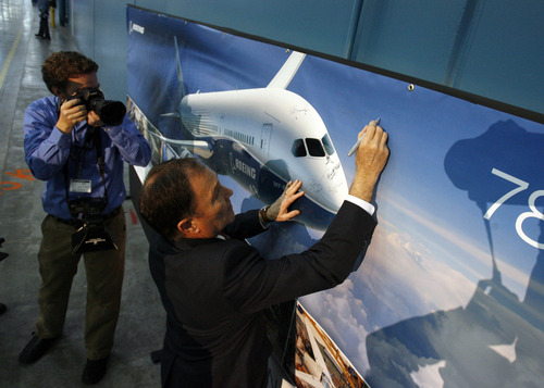 Francisco Kjolseth  |  The Salt Lake Tribune
Gov. Gary R. Herbert adds his name to a banner celebrating the Boeing 787 Dreamliner and the opening of a new manufacturing plant on Friday, January 11, 2013. The company says the factory will create more capacity to meet increasing production rates after purchasing the 850,000-square-foot former Kraft building at 10026 Prosperity Road in West Jordan.