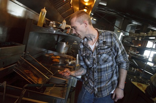 Leah Hogsten  |  The Salt Lake Tribune
Garage chef Jeremy Bloswick fixes a plate of chicken and waffles at The Garage in Salt Lake City.