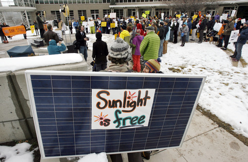 Francisco Kjolseth  |  The Salt Lake Tribune
Jiles Larsen of Salt Lake City wears a solar panel on his back as he joins other environmentalists in a clean-energy rally outside the Calvin L. Rampton Salt Palace Convention Center, where the governor was hosting his Energy Development Summit.