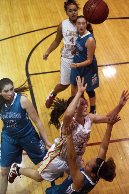 Kim Raff | The Salt Lake Tribune
Juan Diego player (bottom right) is knocked over by Judge Memorial player Kailie Quinn as she shoots two during a game at Judge Memorial in Salt Lake City on January 10, 2013.