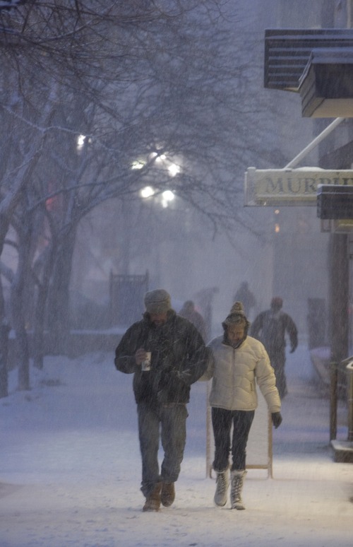 Kim Raff | The Salt Lake Tribune
Pedestrians walks through heavy snow on Main Street during the evening commute in downtown Salt Lake City on January 10, 2013.