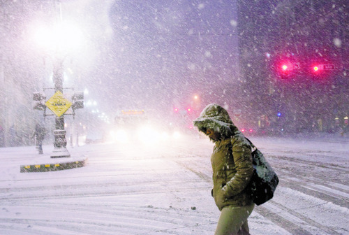 Kim Raff | The Salt Lake Tribune
A pedestrian walks through heavy snow on Main Street during the evening commute in downtown Salt Lake City on January 10, 2013.
