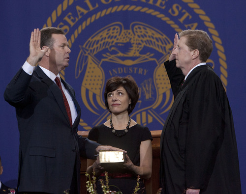Steve Griffin | The Salt Lake Tribune
Attorney General John Swallow, left,  is sworn in by Chief Justice Matthew B. Durrant as his wife, Suzanne, holds the Bible during inauguration ceremonyy at the Utah State Capitol on Monday.
