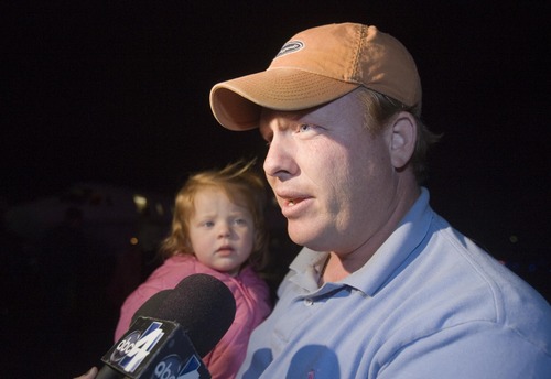 Jim Urquhart  |  The Salt Lake Tribune
Jeremy Johnson holds his daughter Bree Johnson, 2, as he talks to the media after returning to Utah  Tuesday, January 26 2010 at the St. George Airport in St. George.  St. George businessman Jeremy Johnson returned after working two weeks in Haiti also taking with him people affilated with the non-profit Healing Hands for Haiti. He also arranged for some orphans to get out of the country, providing transportation for them. 1/26/10
