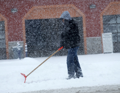 Al Hartmann  |  The Salt Lake Tribune
A man shovels the sidewalk as the snow keeps piling up along a State Street business in Murray on Friday,  Jan. 11.