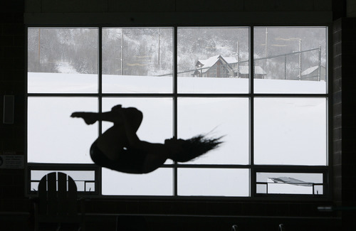 Scott Sommerdorf   |  The Salt Lake Tribune
Outside; freezing and snowy. Inside 75 degrees and humid, as students compete in a high school diving meet at the Ecker Hill pool at the Park City Aquatic Center, Saturday, January 12, 2013.