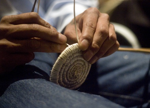 Kim Raff  |  The Salt Lake Tribune
Navajo artist Anderson Black weaves a Navajo basket for visitors during a basket weaving demostration for "A Celebration of Contemporary Navajo Baskets" exhibit, which opened at the Natural History Museum of Utah in Salt Lake City on January 12, 2013. The exhibit features more than 150 works of art created by the basket weavers of Monument Valley, Utah.