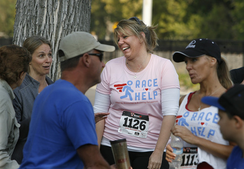 Scott Sommerdorf  |  The Salt Lake Tribune             
Meri Brown, center, from the TV program "Sister Wives," talks with other runners on Sept. 22, 2012, near the starting line of the 5K run to benefit Holding Out Help, a group that helps people leaving polygamy. Brown's family is suing the state of Utah in federal court, claiming the state's bigamy law is unconstitutional.