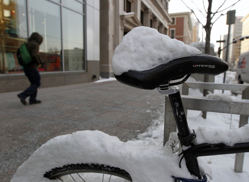 Al Hartmann  |  The Salt Lake Tribune
A mountain bike on Main Street is frozen in place from last week's snowstorm as Salt Lake wakes to the coldest morning of the year Monday, Jan. 14.
