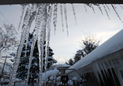 Al Hartmann  |  The Salt Lake Tribune
Icicles cling to a roof in Salt Lake as the sun rises Monday, Jan. 14 to the coldest morning of the year. It was about zero degrees.