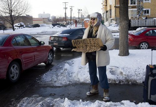 Kim Raff | The Salt Lake Tribune

Michelle Hall, who is homeless, braves the frigid temperatures while panhandling at a shopping center off of 400 South in Salt Lake City on Monday, Jan. 14, 2013. This is Hall's first winter panhandling. "I think it was 1 degree yesterday and I don't think I've ever felt that cold before," says Hall.