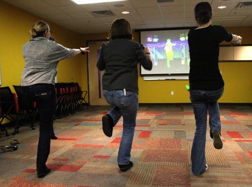 Rick Egan  | The Salt Lake Tribune 
CHG employees play Wii at their office in Salt Lake Thursday. CHG rose from 27th last year to 9th in Fortune's 2012 list of top 100 businesses to work for.