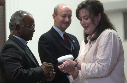 Father Lourduraj Gally, left, and Robert White, the service chief, center, perform blessing of hands ritual for a 2009 chaplain graduate Catherine Toronto at the VA Medical Center on Thursday, July 30, 2009. The VA chaplain-training program has since ended.
Anna Kartashova / The Salt Lake Tribune