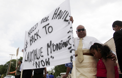 Ashley Detrick  |  The Salt Lake Tribune
Lyndon Lauhingoa stands with his daughter and dozens of others during a protest outside the Tongan United Methodist Church on Sunday September 23, 2012.  Members of the West Valley City church protested the removal of their pastor, Rev. Havili Mone.