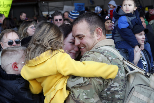 Al Hartmann  |  The Salt Lake Tribune
Staff Sgt. Brady Blake of the 1st Battalion, 211th Aviation hugs his daughter Addison and wife Courtney inside the Utah Air National Guard Base hangar Thursday as 150 members returned from their 12-month deployment to Afghanistan.