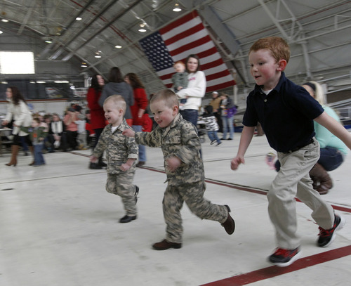 Al Hartmann  |  The Salt Lake Tribune
Twins Riley and Jackson McClellon, 3, and Carter Wilson, 5 burn off some energy running races while waiting for members of the 1st Battalion, 211th Aviation to return after their 12-month deployment to Afghanistan. Hundreds of friends and relatives greeted the 150 soldiers at the Utah Air National Guard Base in Salt Lake City Thursday.
