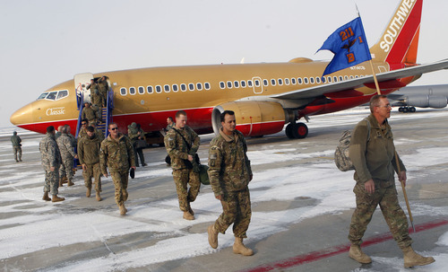 Al Hartmann  |  The Salt Lake Tribune
The first planeload of soldiers from the 1st Battalion, 211th Aviation disembarks at the Utah Air National Guard Base hangar Thursday. Two planes carried home 150 members of the unit after their 12-month deployment to Afghanistan.