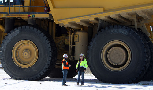Francisco Kjolseth  |  The Salt Lake Tribune
Kyle Bennett, senior adviser of communications for Kennecott Utah Copper and Megan Gaida, acting manager of production support, are dwarfed by the nearly 12-foot tall tires of the hauling trucks at Kennecott which weigh over 400 tons without a payload.