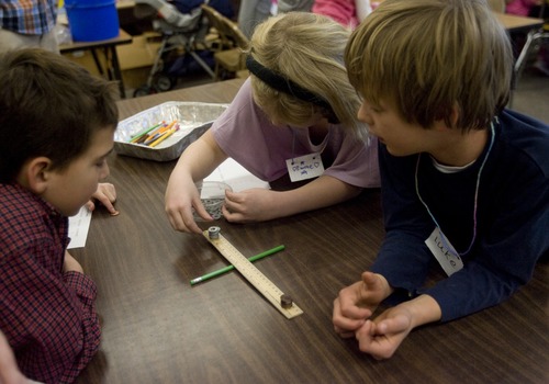 Kim Raff | The Salt Lake Tribune 
(from left) Isaac Oviedo, Emme Gardiner, and Luke Heinrich conduct an experiment to learn about levers during a science lab at Indian Hills Elementary in Salt Lake City on January 14, 2013. The school earned a science grant for its hands-on learning lab.