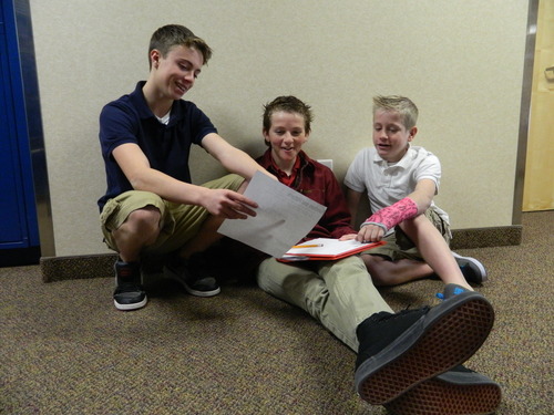 Tyce Petterson, right, Spencer Vockel and Lucas Stowe look over school work at Syracuse Arts Academy. Petterson won a statewide contest for his video essay about Martin Luther King, Jr. Carol Lindsay | Special to The Tribune