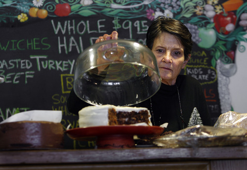 Scott Sommerdorf   |  The Salt Lake Tribune
Uptown Fare owner Karleen Reilly serves cakes on Jan. 9, 2013. During the Sundance Film Festival, Reilly caters to locals at her restaurant at the top of Main Street.