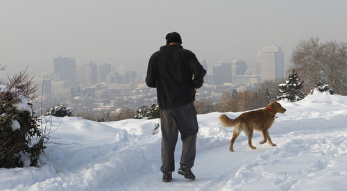 Al Hartmann  |  The Salt Lake Tribune
Man and dog run along 11th Avenue Park track in the avenues above the fog-shrouded Salt Lake City skyline Friday morning January 18.