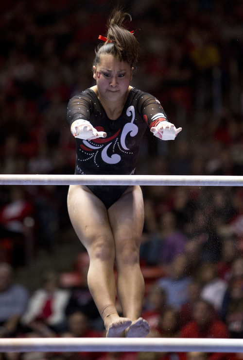 Lennie Mahler  |  The Salt Lake Tribune
Corrie Lothrop performs on the uneven bars earning a 9.825 in a meet against Oregon State, West Virginia, and SUU at the Huntsman Center, Saturday, Jan. 19, 2013. The Red Rocks edged the competition with a final score of 196.950, followed by Oregon State with a score of 195.950.