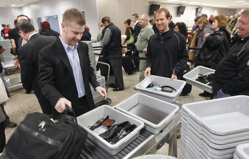 Al Hartmann  |  The Salt Lake Tribune
Fliers at Salt Lake City International Airport, Terminal 2, security checkpoint place  personal carry on items likes, shoes, jackets, and small  luggage into plastic bins to go through X-ray machine Tuesday January 15 at 7:30 a.m.