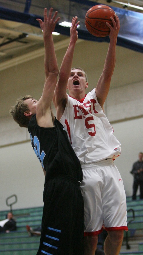 Kim Raff  |  The Salt Lake Tribune
(right) East player Parker Van Dyke shoots the ball as (left) Sky View player McKay Spackman defends during the Jordan Holiday Torney at Juan Diego High School in Draper on December 27, 2012. East went on to win the game 64-46.