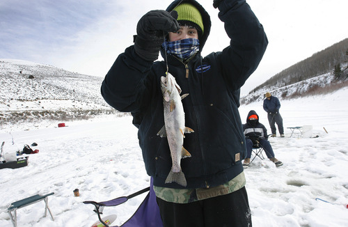 Scott Sommerdorf   |  The Salt Lake Tribune
Isaac Greenfield holds up the 15 inch Cutthroat Trout he caught at Scofield Reservoir, Saturday, December 29, 2012. He was not part of the Utah State Parks "Trifishalon" ice fishing tournament. The first leg of the tournament was Saturday at Scofield Reservoir.