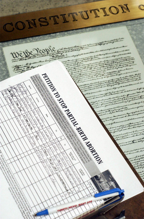 A petition to stop partial-birth abortion sits on a copy of the U.S. Constitution on display in the rotunda of Utah's Capitol Wednesday, Jan. 22, 2003, in Salt Lake City. On the 30th anniversary of the Roe v. Wade decision, Utah Rep. Mike Thompson, R-Orem, announced legislation to define at what stage during pregnancy an abortion becomes "infanticide'' and setting criminal penalties for such cases. (AP Photo/Salt Lake Tribune, Ryan Galbraith) -UTSAL, Deseret News Out, Local TV Out, Mags Out.