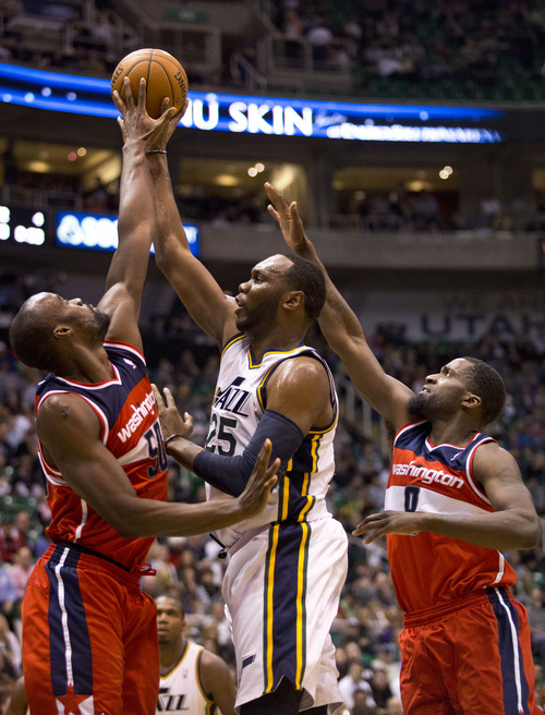 Lennie Mahler  |  The Salt Lake Tribune
Jazz center Al Jefferson is blocked by Washington's Emeka Okafor with defense from Martell Webster (right) in the first half of a game at EnergySolutions Arena in Salt Lake City, Utah. Wednesday, Jan. 23, 2013.