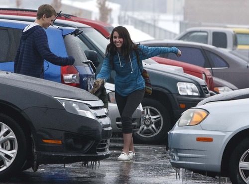 Leah Hogsten  |  The Salt Lake Tribune
Mariah Border and Tanner Nelson, both seniors at Northridge High School had a fun time "skating" in the parking lot of the school before leaving for the day. A rare fall of freezing rain triggered hundreds of northern Utah traffic accidents and closed runways at Salt Lake City International Airport  as it turned interstate freeways and tarmac alike into skating rinks,Thursday January 24, 2013.