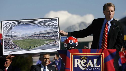 Tribune file photo
Dave Checketts, owner of Real Salt Lake, holds up a rendering of the future Real soccer stadium in Sandy.