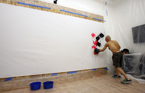 Rick Egan  | The Salt Lake Tribune 

81-year-old old Japanese artist, Ushio Shinohara, punches his art on to the canvas, with boxing gloves covered in sponges, at the Central Utah Art Center, Monday, January 21, 2013. Shinohara, is featured in the Sundance documentary film "Cutie and the Boxer."
