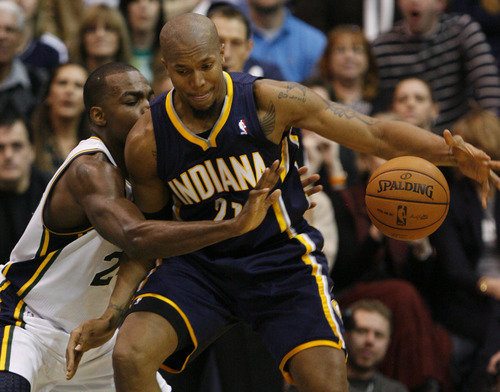 Rick Egan  | The Salt Lake Tribune 

Utah Jazz power forward Paul Millsap (24) is called for a foul, as he knocks the ball away from Indiana Pacers power forward David West (21), in NBA action, Jazz vs. Indiana game, Saturday, January 26, 2013.