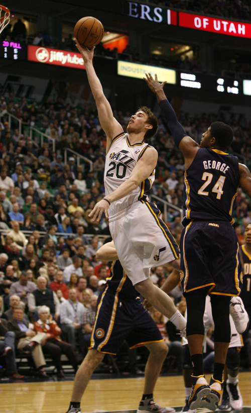 Rick Egan  | The Salt Lake Tribune 

Utah Jazz shooting guard Gordon Hayward (20) goes in for two points as Indiana Pacers small forward Paul George (24) defends, in NBA action,  Jazz vs. Indiana game, Saturday, January 26, 2013.