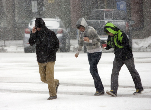 Kim Raff  |  The Salt Lake Tribune
People make their way down Main Street as heavy snow falls in Salt Lake City on January 27, 2013.