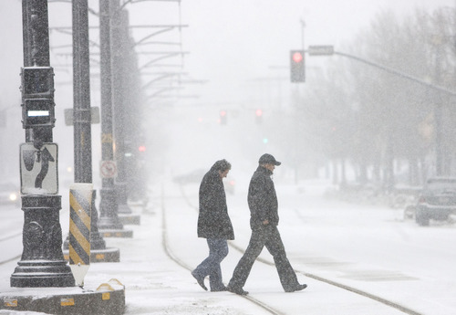 Kim Raff  |  The Salt Lake Tribune
People make their way downtown as heavy snow falls in Salt Lake City on January 27, 2013.