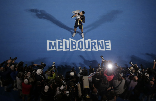 Serbia's Novak Djokovic holds his trophy after defeating Britain's Andy Murray in the men's final at the Australian Open tennis championship in Melbourne, Australia, Sunday, Jan. 27, 2013.(AP Photo/Rob Griffith)